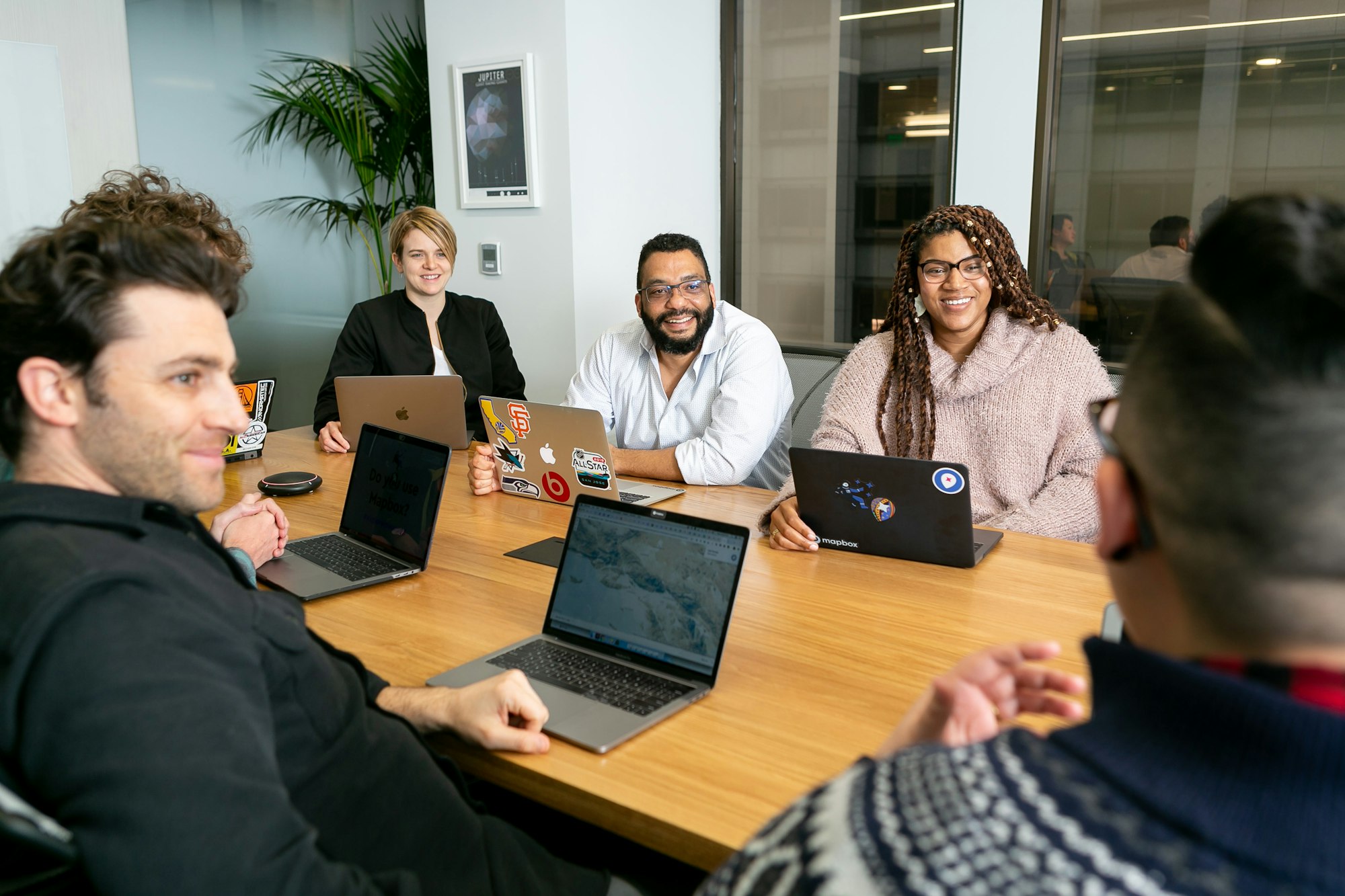 Un equipo de finanzas revisa juntos un lote de pagos en sus laptops